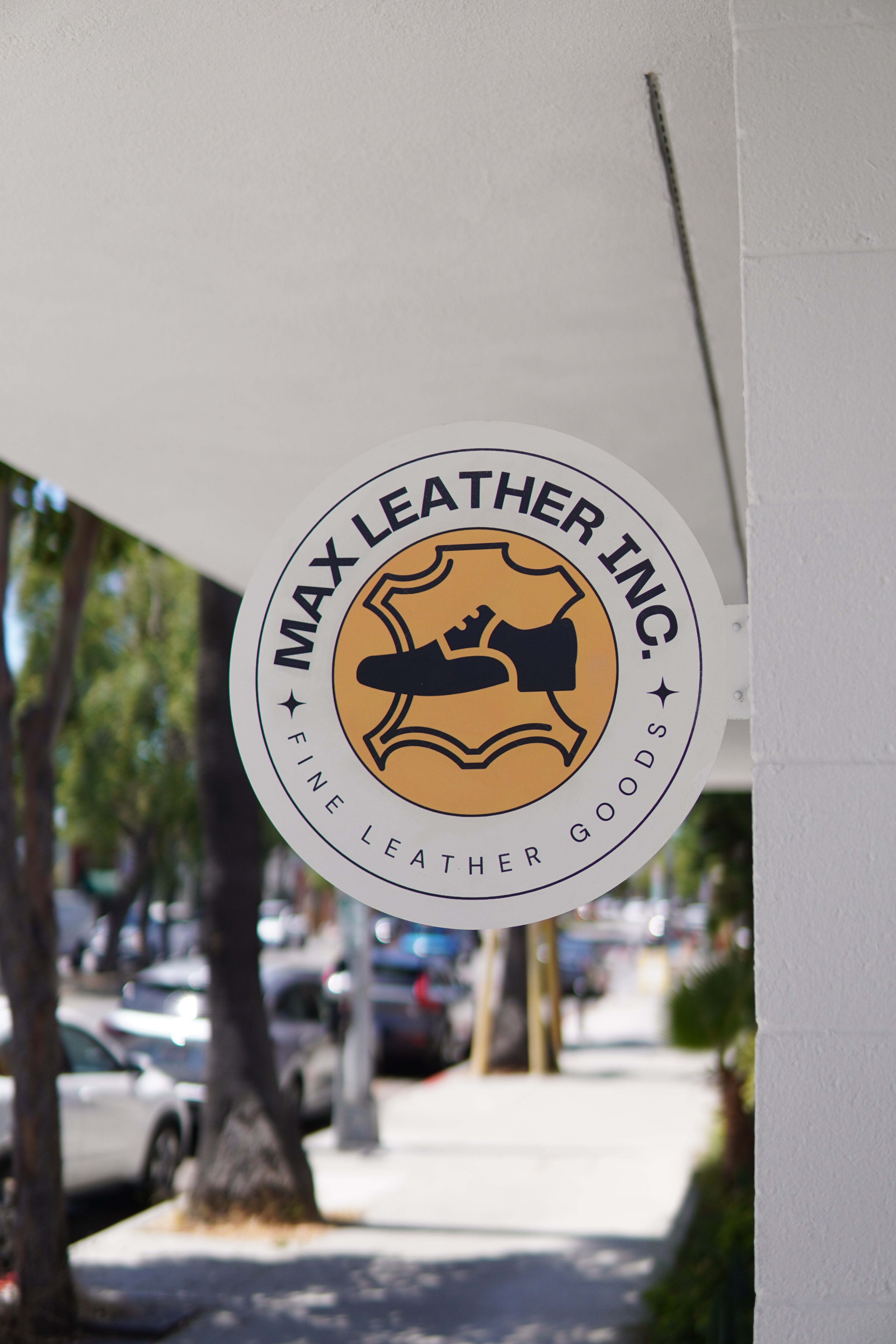 Max Leather Goods logo on a product with a blurred background