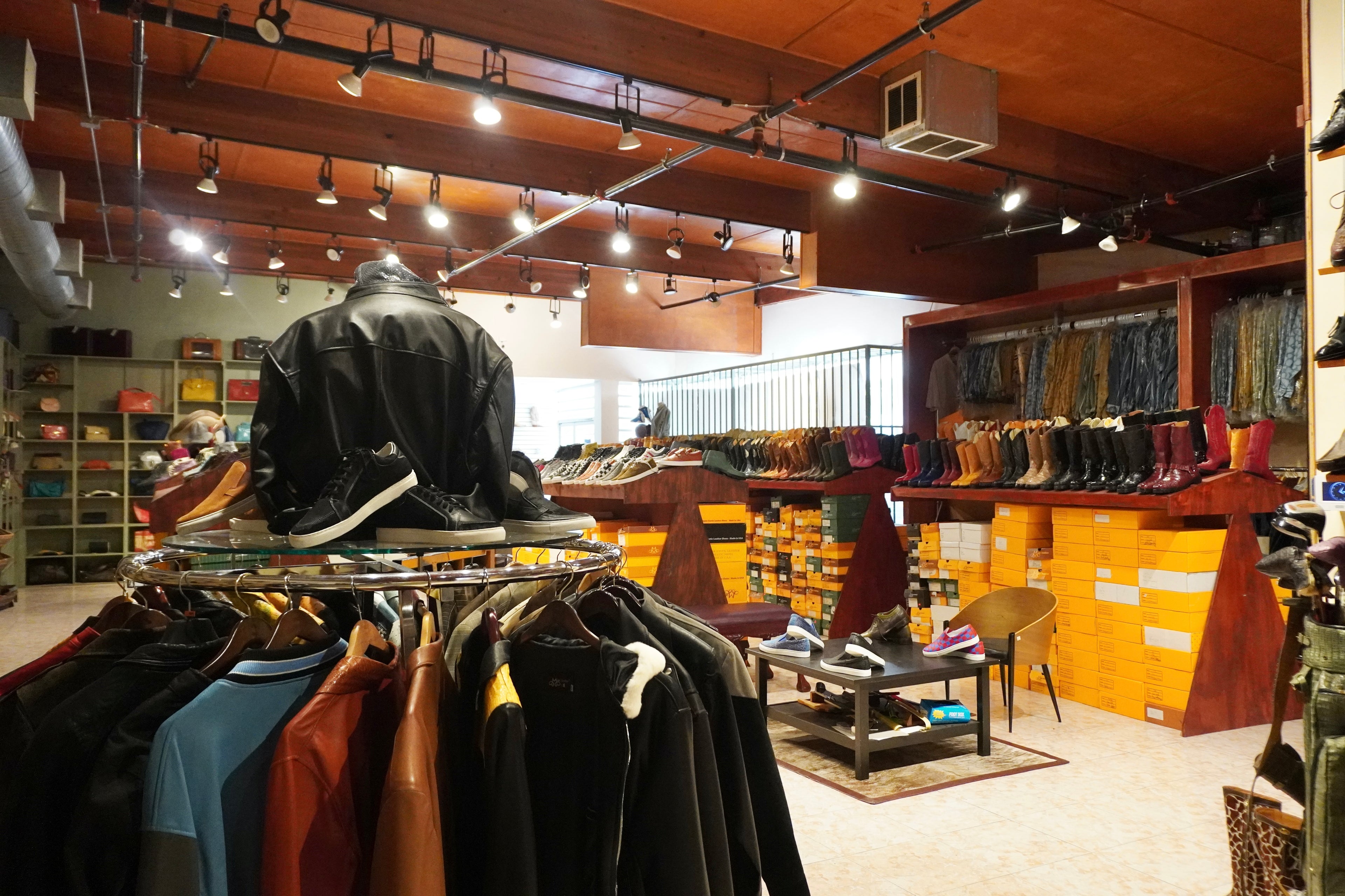 Interior of a clothing store with racks of clothes and shelves displaying various items.